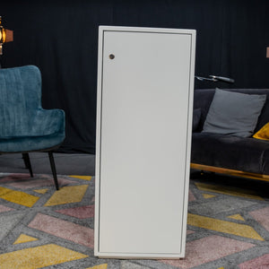 White storage plinth with a lockable door, shown in a styled room setting