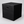 Black square drama podium block with handhold on a light grey studio background