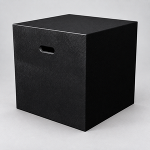 Black square drama podium block with handhold on a light grey studio background