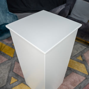 White retail display plinth with capped top