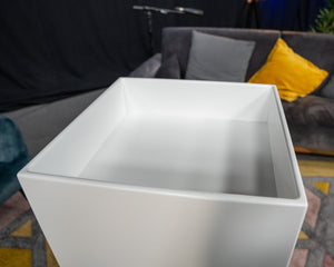 White dropped top plinth at a live event