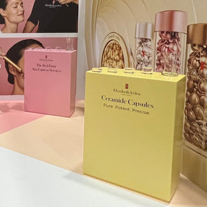 Yellow branded retail display counter with lockable doors on an Elizabeth Arden stand